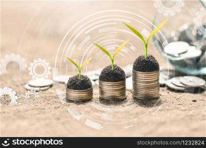 The seedlings are growing on coin placed on dry ground while the digital icons are included.