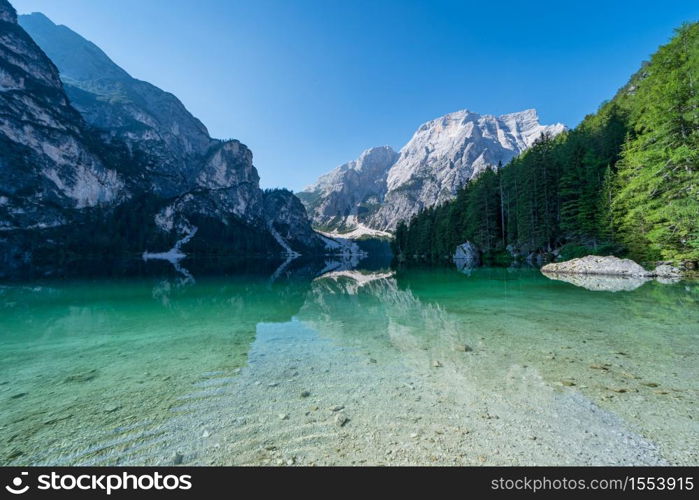 The Seekofel mountain reflected in the clear waters of Lake Braies, Italian landscape in South Tyrol