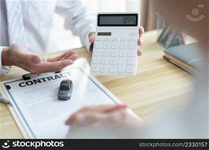 The selling agent informing his client about the expense by showing it on the calculator.