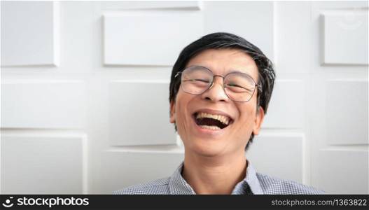 The senior Asian man smiled and laughed happy