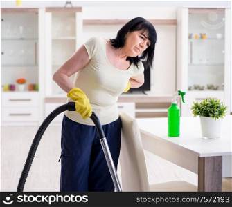 The senior old woman tired after vacuum cleaning house. Senior old woman tired after vacuum cleaning house