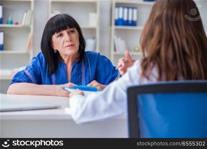 The senior patient visiting doctor for regular check-up. Senior patient visiting doctor for regular check-up