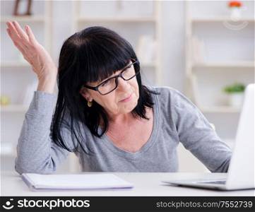 The senior woman struggling at computer. Senior woman struggling at computer