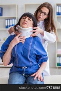 The senior woman with neck injury at doctors. Senior woman with neck injury at doctors