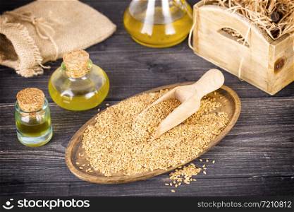 The sesame and oil on old wooden background