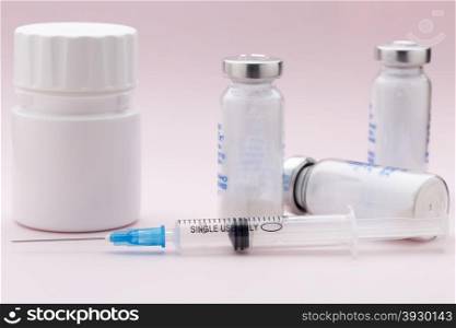 The set of solutions for injection and one syringe. The set of solutions for injection and one syringe on pink background