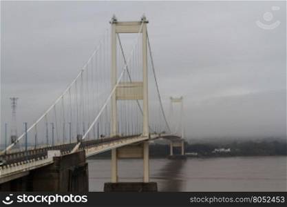 The Severn Bridge (welsh Pont Hafren) crosses from England to Wales across the rivers Severn and Wye. Misty morning view from England side.