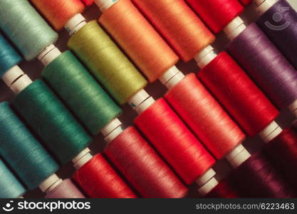 The sewing threads multicolored background close up. The sewing background