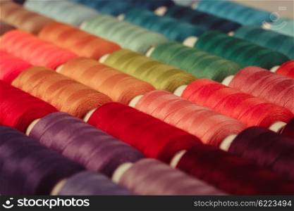 The sewing threads multicolored background close up. The sewing background