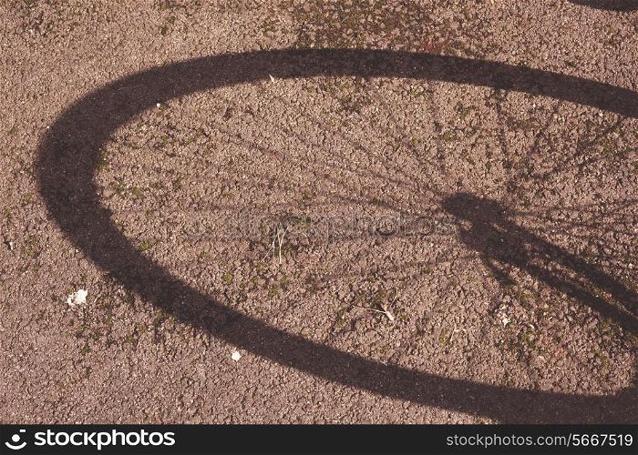 The shadow of a bike wheel