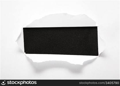 the sheet of paper with the rectangular hole against the black background