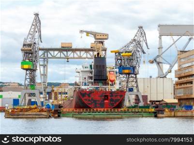 The ship is repaired in a large marine dock.. Gdynia. Cargo ship at the dock.