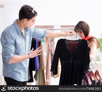 The shop assistant helping woman with buying choice. Shop assistant helping woman with buying choice