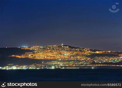 The shore of Lake Kinneret and the city of Tiberias at night