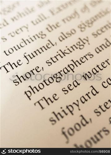 the shore photographers. words in a book with blur effect