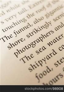 the shore photographers. words in a book with blur effect