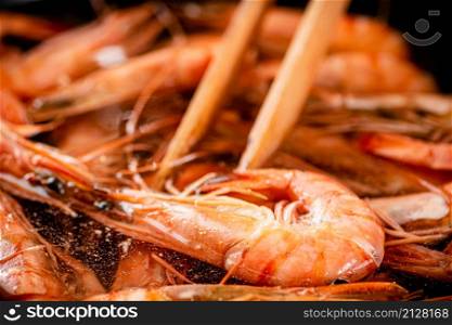The shrimp are cooked in a pot of water. Macro background. High quality photo. The shrimp are cooked in a pot of water.