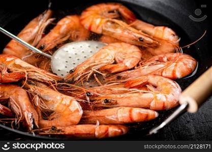 The shrimp are cooked in a pot of water. Macro background. High quality photo. The shrimp are cooked in a pot of water.