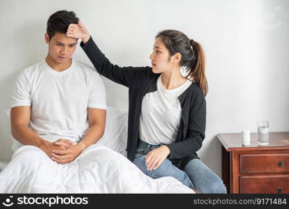 The sick man had a woman look and touch his forehead.