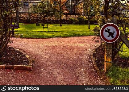 The sign prohibiting walking dogs in a park in Belgium. A sign telling you that this is not a dog toilet area.