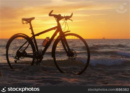 the silhouette of a Bicycle on the beach, Bicycle at sunset. Bicycle at sunset, the silhouette of a Bicycle on the beach