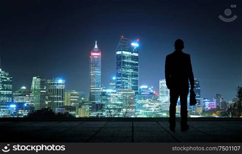 The silhouette portraitof businessman on the roof to see the scenery. Concept of vision of the future .