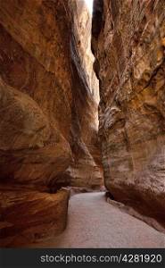 The Siq, the narrow slot-canyon that serves as the entrance passage to the hidden city of Petra, Jordan,