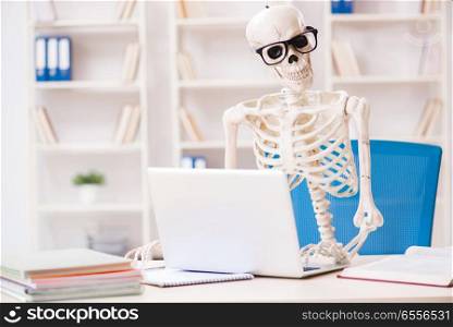 The skeleton businessman working in the office. Skeleton businessman working in the office