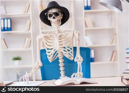 The skeleton businessman working in the office. Skeleton businessman working in the office