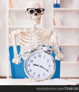 The skeleton businessman working in the office. Skeleton businessman working in the office