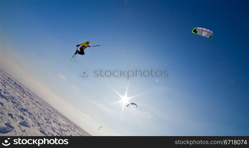 the Ski kiting and jumping on a frozen lake