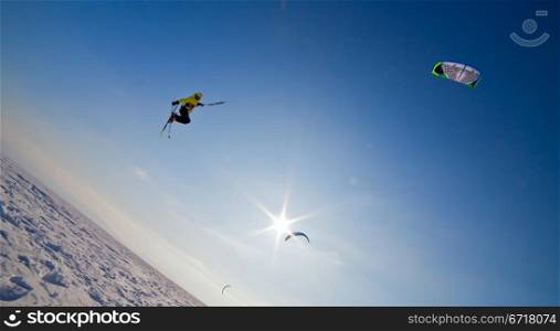 the Ski kiting and jumping on a frozen lake