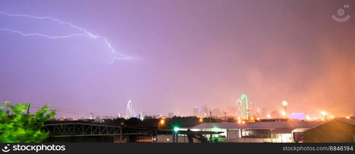 The sky is lit up purple over Dallas during a summer thunderstorm