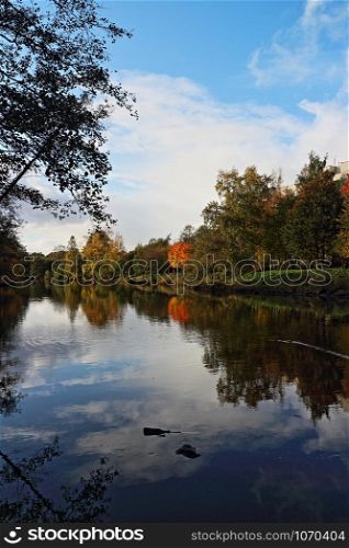 the sky is reflected in a beautiful autumn landscape
