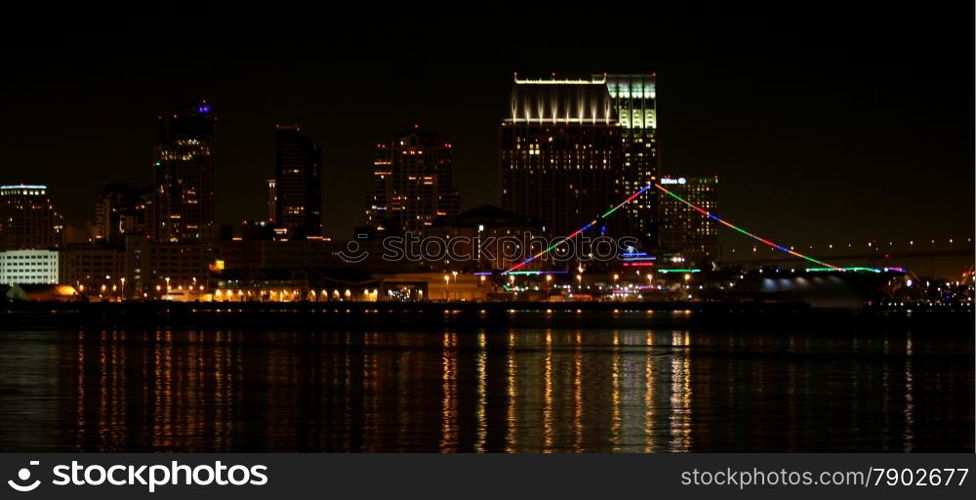 The skyline of San Diego at night with reflection in the water.