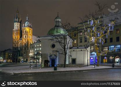 The small Church of St Adalbert and the Church of St Mary in the Main Square (Rynek Glowny) in Krakow, Poland.