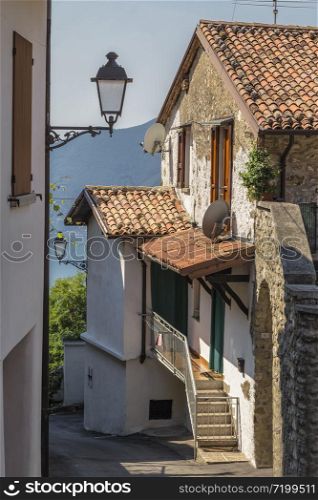 The small street of a small Italian town on the shore of Lake Iseo. Lombardy. Italy