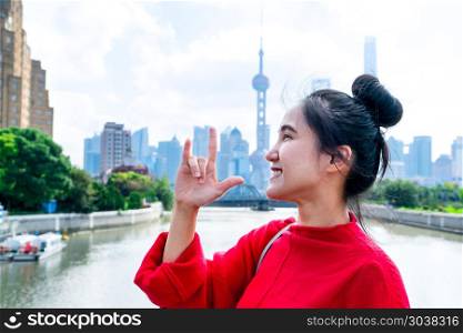 the smile woman body language of love sign with the urban Shangh. the smile woman body language of love sign with the urban Shanghai landmark city