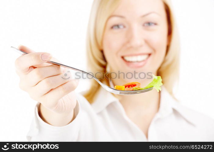 The smiling blonde holds a plug with the salad, isolated. Healthy food