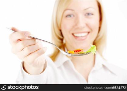 The smiling blonde holds a plug with the salad, isolated. Healthy food
