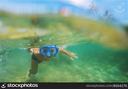 The snorkeling boy at coral reef on Sri Lanka