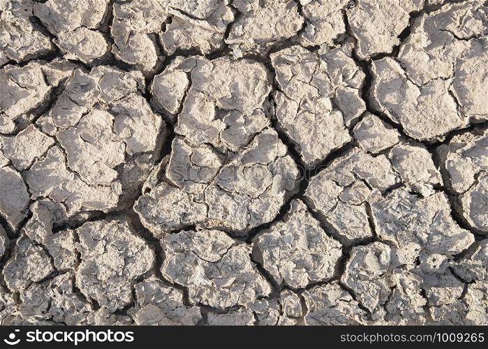 The soil has cracks in the top view of the background or graphic design with the concept of drought and death. texture and background