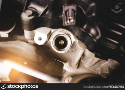 The spark plug socket of a car engine without an ignition coil in the car engine compartment