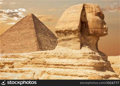The Sphinx and the Pyramid of Cheops, close view, Giza, Egypt.. The Sphinx and the Pyramid of Cheops, close view, Giza, Egypt