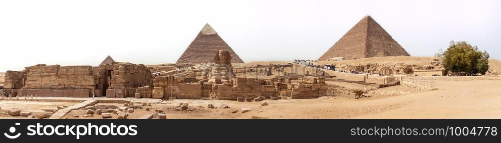 The Sphinx and the Pyramids panorama in Giza, Egypt.. The Sphinx and the Pyramids panorama, Giza, Egypt
