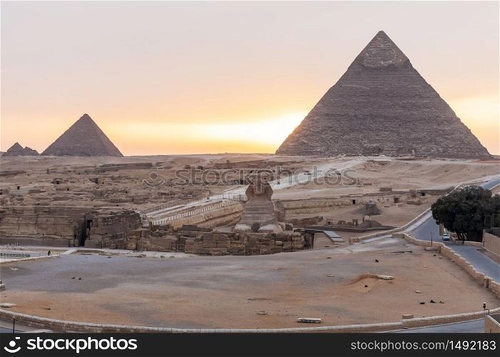 The Sphinx, the Pyramid Of Khafre and the Pyramid of Menkaure in Giza at sunset, Egypt.. The Sphinx, the Pyramid Of Khafre and the Pyramid of Menkaure in Giza at sunset, Egypt