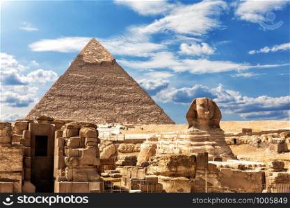 The Sphinx, the Temple and the Pyramid of Chephren under the clouds in Giza.. The Sphinx, the Temple and the Pyramid of Chephren under the clouds in Giza