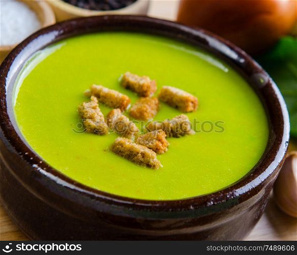 The spinach soup served on wooden board. Spinach soup served on wooden board