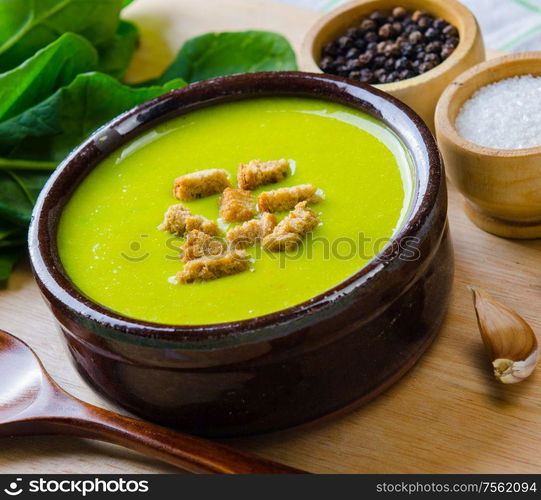 The spinach soup served on wooden board. Spinach soup served on wooden board