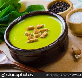 The spinach soup served on wooden board. Spinach soup served on wooden board
